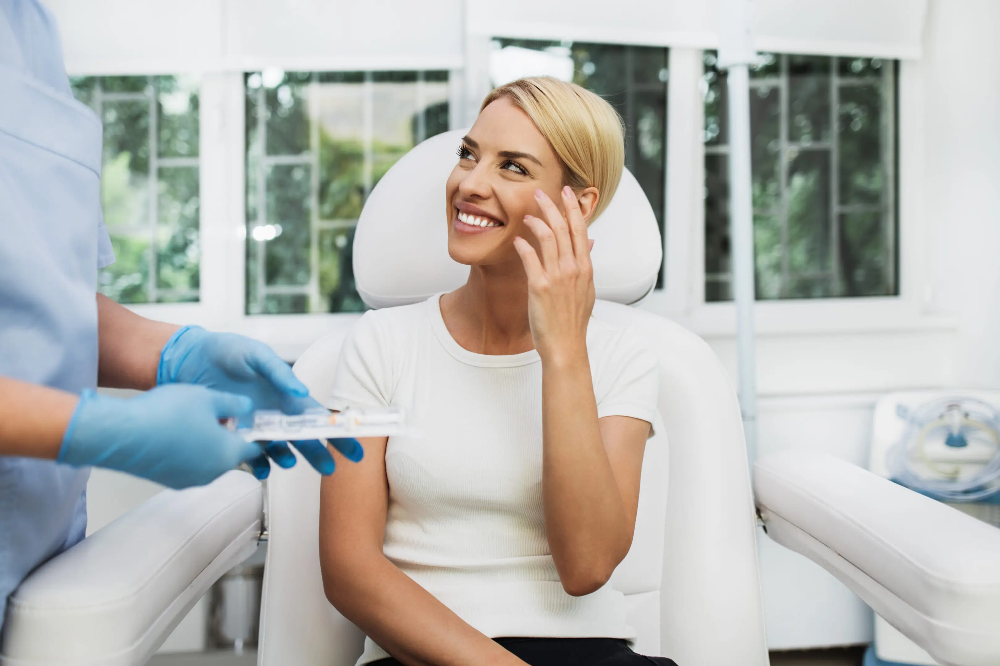 Woman smiling in a medical office chair.
