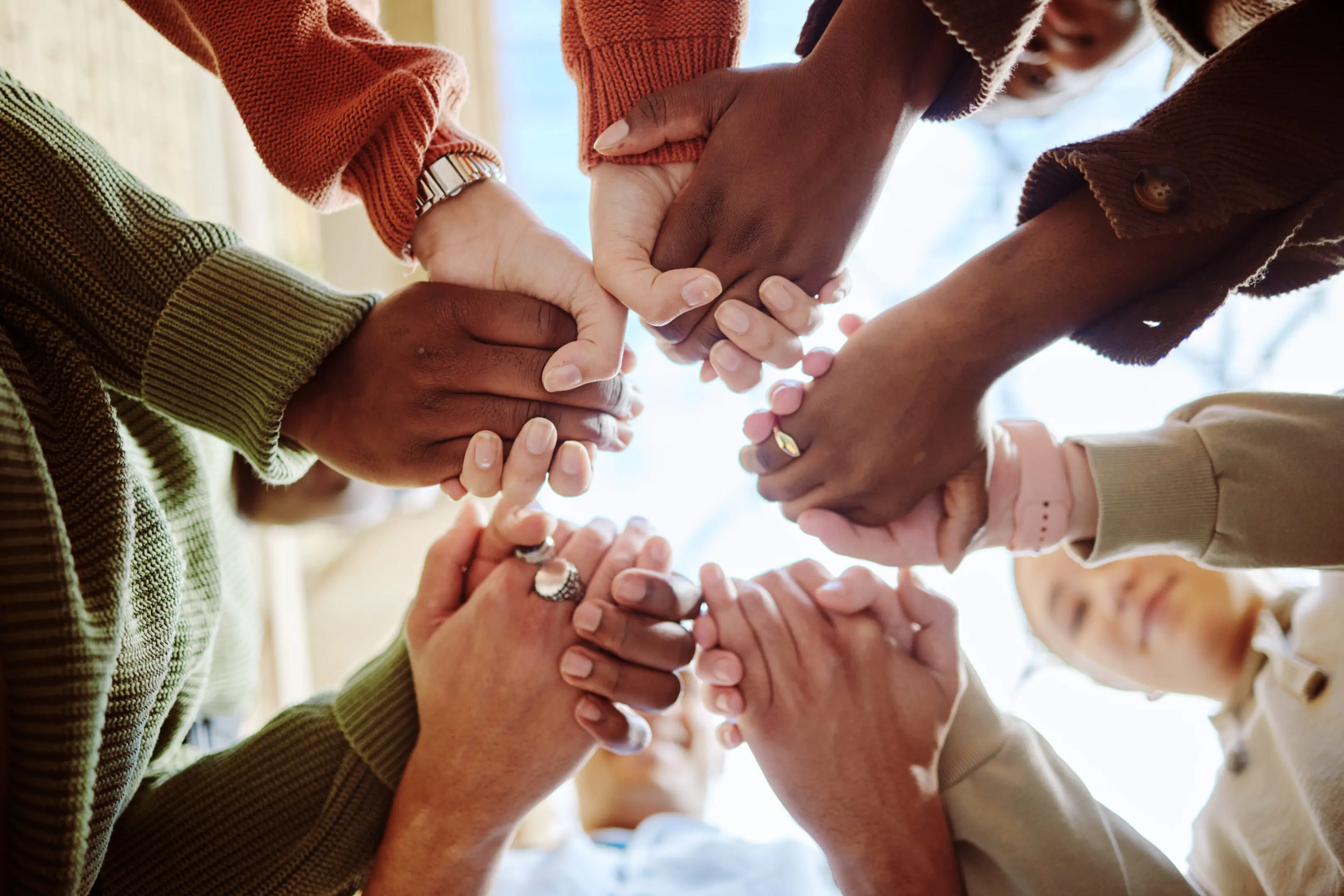 Diverse group holding hands in unity.